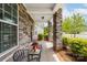Spacious front porch featuring stone columns, comfortable seating, and charming curb appeal at 732 Wood Lily Dr, Belmont, NC 28012