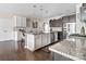 Bright kitchen with two-tone cabinets, granite countertops, stainless steel appliances, and a spacious island at 732 Wood Lily Dr, Belmont, NC 28012