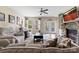 Inviting living room with a stone fireplace, built-in shelving, neutral paint, and a ceiling fan at 732 Wood Lily Dr, Belmont, NC 28012
