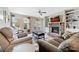 Cozy living room featuring a stone fireplace, built-in shelving, neutral paint, ceiling fan, and comfortable seating at 732 Wood Lily Dr, Belmont, NC 28012