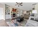 Spacious living room with a fireplace, built-in shelving, hardwood floors, and an open view into the kitchen at 732 Wood Lily Dr, Belmont, NC 28012