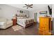 Comfortable main bedroom with a wooden bed frame, dresser, and hardwood floors at 732 Wood Lily Dr, Belmont, NC 28012