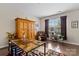 Bright home office with hardwood floors, a large desk, and ample natural light from the window at 732 Wood Lily Dr, Belmont, NC 28012