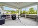 Relaxing screened porch with ceiling fan, offering a tranquil outdoor living space at 732 Wood Lily Dr, Belmont, NC 28012