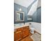 Stylish bathroom with wooden vanity, decorative mirror, and wainscoting at 8300 Quarters Ln, Mint Hill, NC 28227