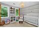 Bedroom with a charming chandelier, patterned accent wall, and bright natural light from large windows at 8300 Quarters Ln, Mint Hill, NC 28227