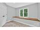 Bedroom with built-in desk and bench and window overlooking a leafy yard at 8300 Quarters Ln, Mint Hill, NC 28227