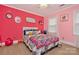 Pink bedroom with a fun vibrant aesthetic, featuring a colorful bed and whimsical decor at 8300 Quarters Ln, Mint Hill, NC 28227