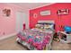 Bright bedroom with pink walls, showcasing a cozy bed and playful decorations at 8300 Quarters Ln, Mint Hill, NC 28227