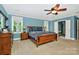 Bright main bedroom featuring a ceiling fan, natural light, and adjoining bathroom at 8300 Quarters Ln, Mint Hill, NC 28227