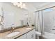 Bathroom features a double vanity with granite countertop, framed mirror, and shower-tub combo at 837 Kathy Dianne Dr, Indian Land, SC 29707