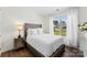 Bright bedroom featuring a large window, neutral color scheme, and dark wood floors at 837 Kathy Dianne Dr, Indian Land, SC 29707