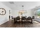 Elegant dining room with dark hardwood floors, modern light fixture and a dark wood dining table at 837 Kathy Dianne Dr, Indian Land, SC 29707