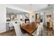 Open floorplan featuring the dining room with wood table and view to the staircase and open kitchen at 837 Kathy Dianne Dr, Indian Land, SC 29707