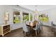 Inviting dining room featuring a large wood table, elegant chairs, and a view of the outdoor living space at 837 Kathy Dianne Dr, Indian Land, SC 29707