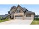 Stunning two-story home with a stone and brick exterior and a long driveway to the garages at 837 Kathy Dianne Dr, Indian Land, SC 29707