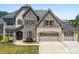Beautiful two-story home with a stone and brick facade and a spacious three-car garage at 837 Kathy Dianne Dr, Indian Land, SC 29707