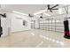 Spacious garage with epoxy floors, ceiling fans, EV charger, and multiple garage doors at 837 Kathy Dianne Dr, Indian Land, SC 29707