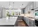 Bright, open kitchen featuring gray cabinetry, white countertops, stainless steel appliances, and dark wood floors at 837 Kathy Dianne Dr, Indian Land, SC 29707