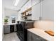 Modern laundry room with white cabinets and black appliances is bright and spacious at 837 Kathy Dianne Dr, Indian Land, SC 29707