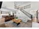 Open-concept living room with hardwood floors and a staircase to the second floor at 837 Kathy Dianne Dr, Indian Land, SC 29707