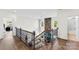 Bright loft space with dark wood floors, staircase, and a stone fireplace at 837 Kathy Dianne Dr, Indian Land, SC 29707