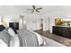 Bright main bedroom features wood floors, a ceiling fan, and a view to the stairway at 837 Kathy Dianne Dr, Indian Land, SC 29707