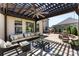 Inviting covered patio featuring a lounge area, ceiling fan, and outdoor kitchen with grill and fireplace at 837 Kathy Dianne Dr, Indian Land, SC 29707