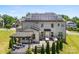 A beautifully landscaped backyard featuring a patio, outdoor kitchen, and solar panels on the roof at 837 Kathy Dianne Dr, Indian Land, SC 29707