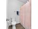 Functional bathroom with a toilet and shower, accented by a pink shower curtain at 8416 Highgate Dr, Charlotte, NC 28215
