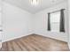 Empty bedroom with wood flooring and a well-lit window at 8416 Highgate Dr, Charlotte, NC 28215