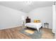 Spacious bedroom with hardwood floors, a cozy bed, and natural light at 8416 Highgate Dr, Charlotte, NC 28215
