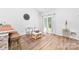 Bright dining area with wood-look flooring, a large clock, and elegant furnishings at 8416 Highgate Dr, Charlotte, NC 28215