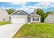 Charming single-story home with a well-manicured lawn, a two-car garage, and beautiful landscaping at 8416 Highgate Dr, Charlotte, NC 28215