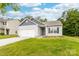 Charming single-story home with manicured lawn, attached garage, and flower beds under a bright, sunny sky at 8416 Highgate Dr, Charlotte, NC 28215