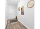 Hallway featuring stylish decor and wood-look flooring, leading to various rooms at 8416 Highgate Dr, Charlotte, NC 28215