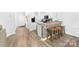 Kitchen featuring a breakfast bar with seating, modern appliances, and wood-look flooring at 8416 Highgate Dr, Charlotte, NC 28215
