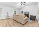 Cozy living room featuring vaulted ceilings, wood-look flooring, and comfortable seating at 8416 Highgate Dr, Charlotte, NC 28215