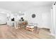 Open-concept living area with wood-look flooring, breakfast bar and dining chairs at 8416 Highgate Dr, Charlotte, NC 28215