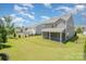 Wide backyard showing a well-maintained lawn and a screened patio at 8420 Golden Stone Ln # 138, Fort Mill, SC 29707
