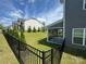 Backyard showing a screened porch, green lawn, and decorative fencing that enhances the property's charm at 8420 Golden Stone Ln # 138, Fort Mill, SC 29707