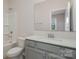 Bathroom featuring gray vanity, a white countertop, a large mirror, and a tub with shower at 8420 Golden Stone Ln # 138, Fort Mill, SC 29707