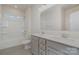 Bathroom featuring gray vanity, a white countertop, a large mirror, and a tub with shower at 8420 Golden Stone Ln # 138, Fort Mill, SC 29707