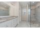 Bathroom features a granite countertop, double sinks, and walk-in shower with glass enclosure at 8420 Golden Stone Ln # 138, Fort Mill, SC 29707