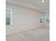 Spacious bedroom featuring neutral walls and carpet, crown molding, and three bright windows at 8420 Golden Stone Ln # 138, Fort Mill, SC 29707