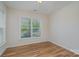 Bright bedroom featuring hardwood floors and a large window providing lots of natural light at 8420 Golden Stone Ln # 138, Fort Mill, SC 29707