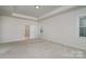 Large, bright bedroom with neutral carpet and walls, leading to an ensuite bath with a glass shower at 8420 Golden Stone Ln # 138, Fort Mill, SC 29707