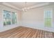 Dining room featuring hardwood floors, modern chandelier, wainscoting, and lots of natural light at 8420 Golden Stone Ln # 138, Fort Mill, SC 29707