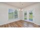 Dining room featuring hardwood floors, modern chandelier, French doors and large window at 8420 Golden Stone Ln # 138, Fort Mill, SC 29707