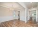 Formal dining room with wainscoting, hardwood floors and a stylish chandelier at 8420 Golden Stone Ln # 138, Fort Mill, SC 29707